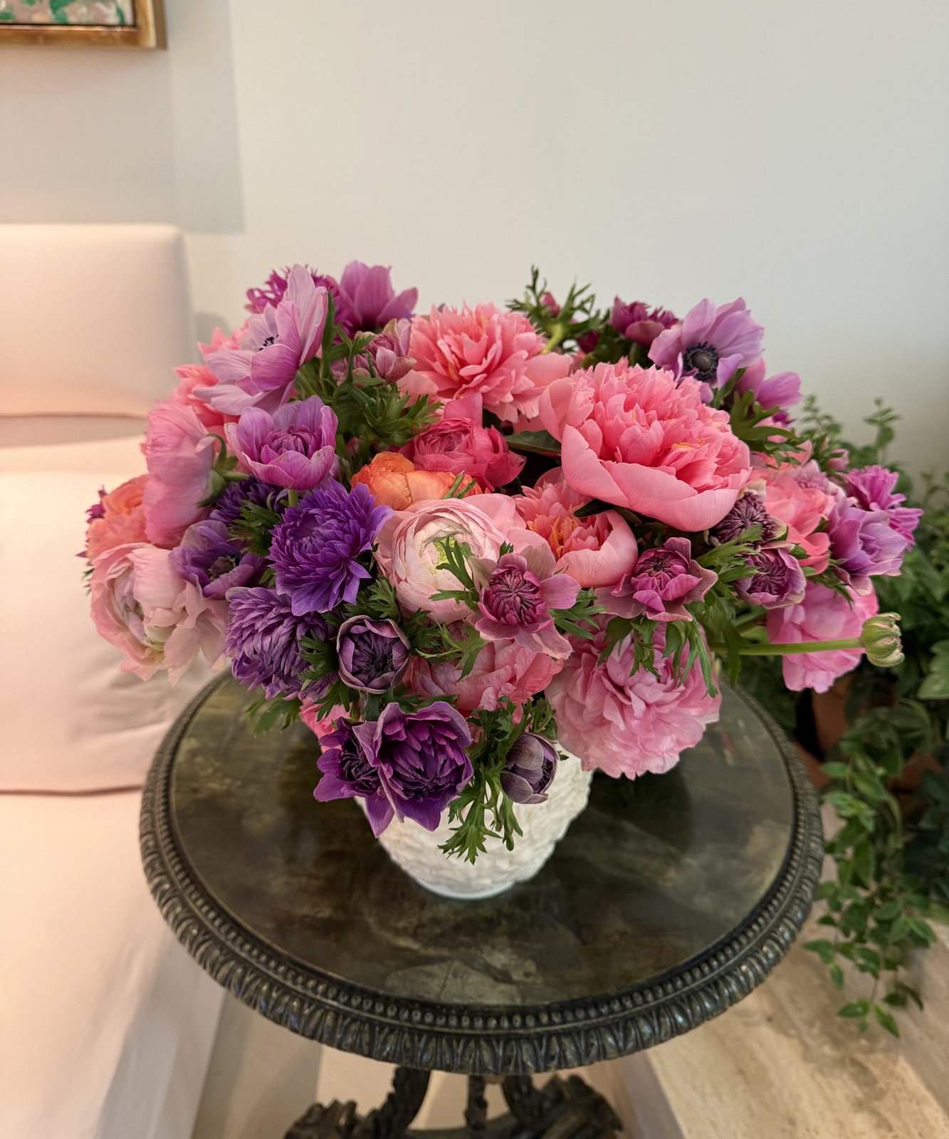 Peony and anemone arrangement in a white vase