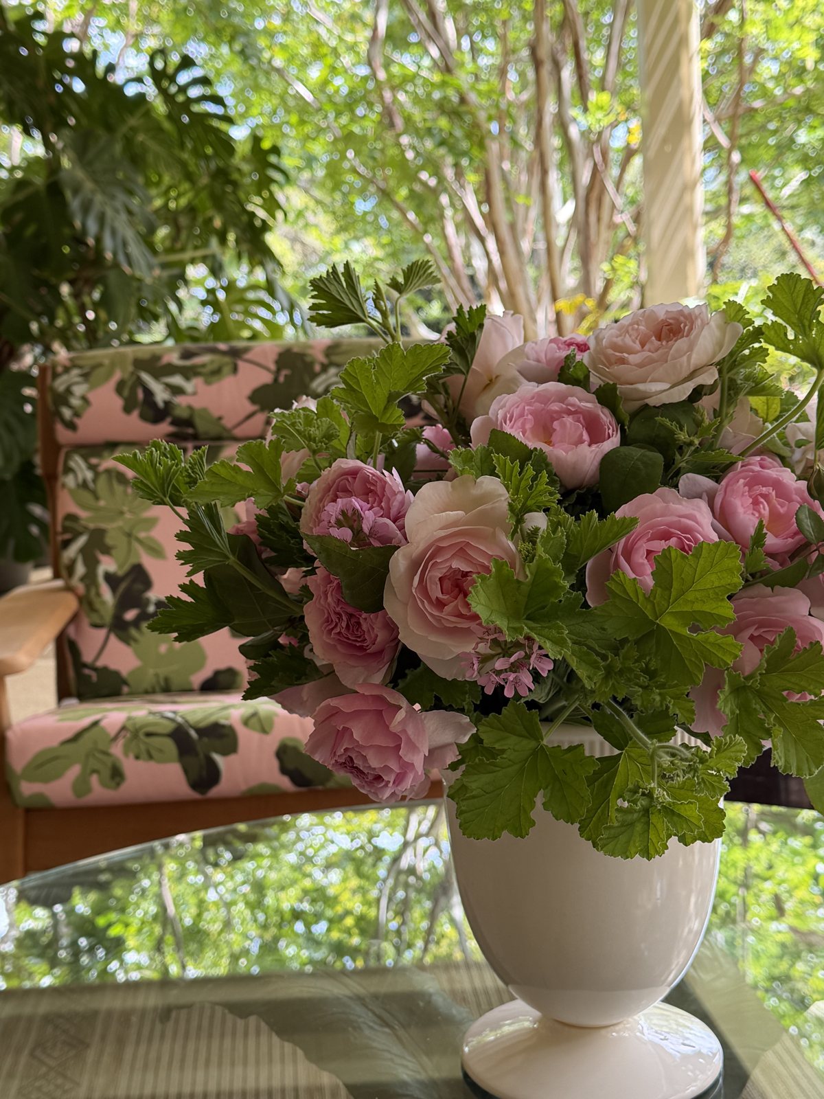 Garden roses and scented geranium on a sun porch