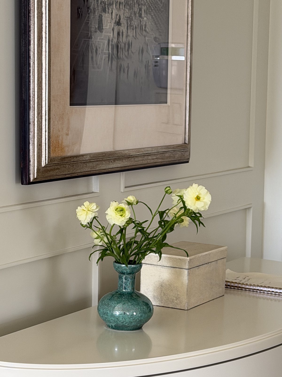 Butter ranunculus in a teal bud vase